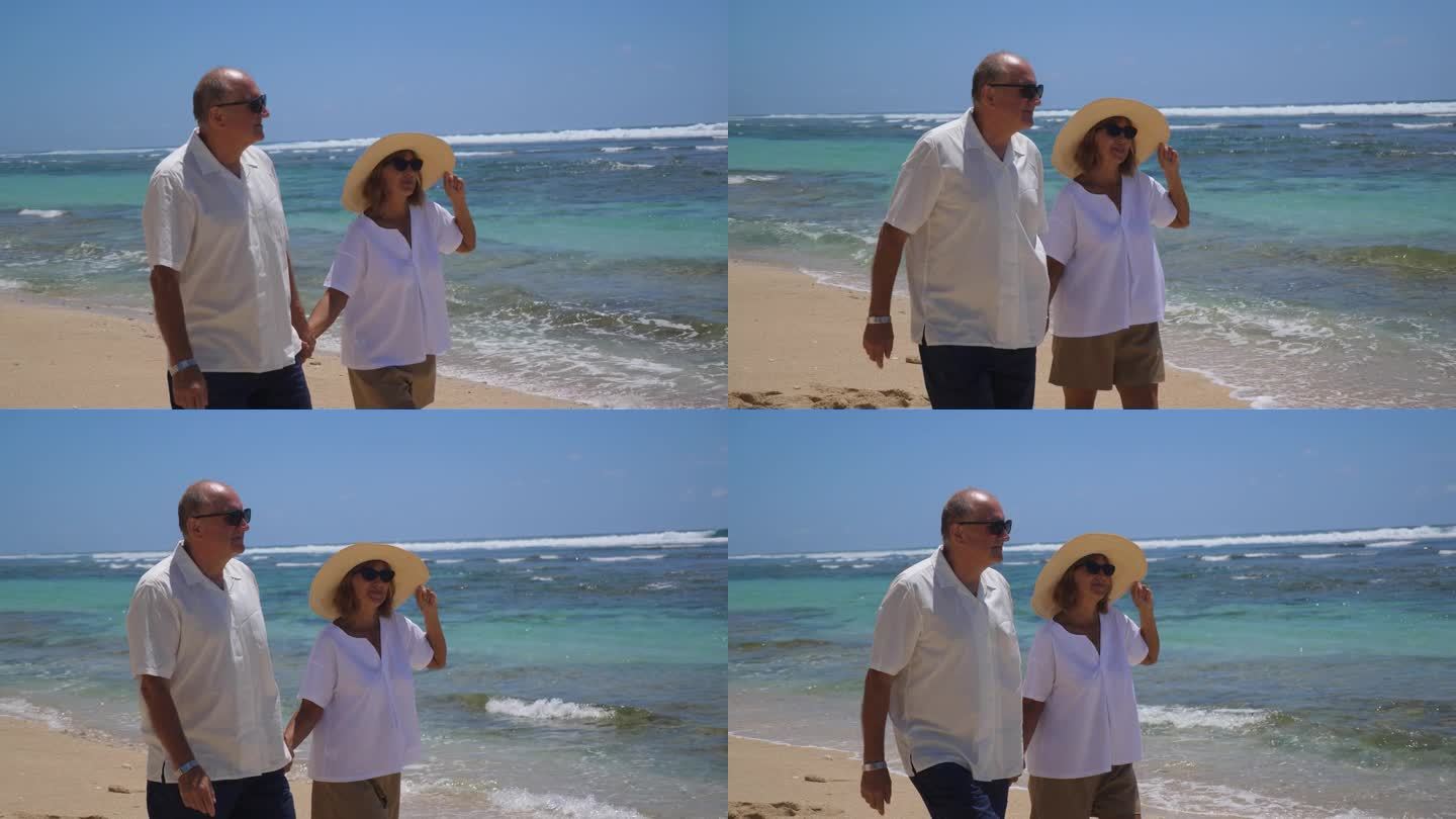 老年夫妇沿着阳光明媚的海滩浪漫漫步。一个男人和一个女人在海滩上度假。以沙滩和海景之美为背景的关系和谐