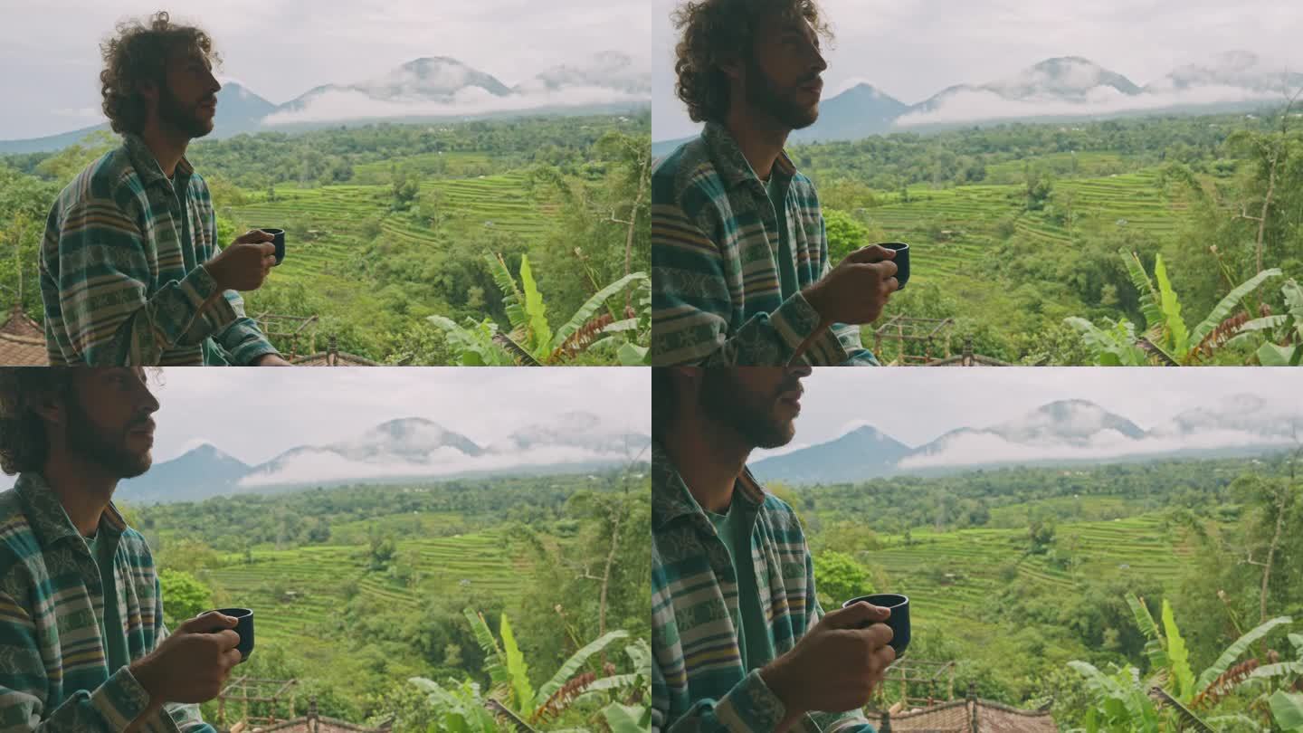 一个人在巴厘岛边喝咖啡边看稻田