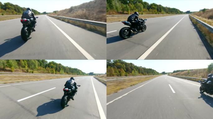 夏日，骑摩托车的人在公路旅行中驾驶摩托车。男子在高速公路上快速骑着现代运动摩托车。摩托车手在乡间小路