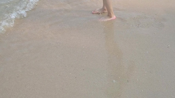 慢镜头，近距离拍摄赤脚孩子在夏日海上旅行的沙滩上快乐玩耍的场景