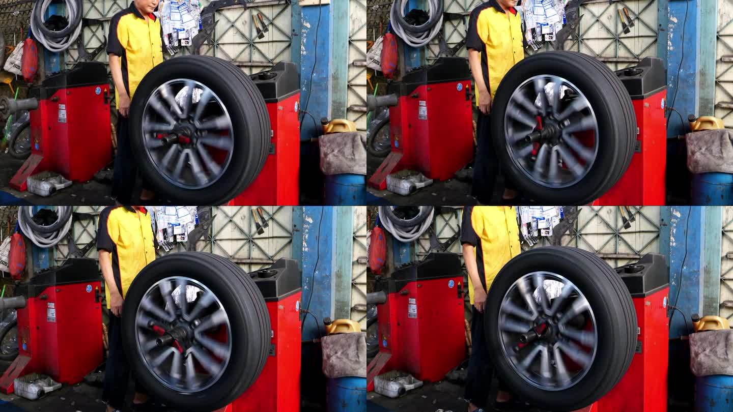 车轮平衡器在工作，以控制的速度转动合金车轮。