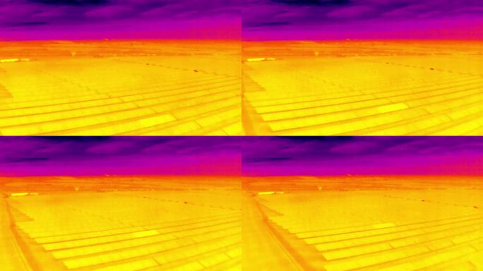大型光伏农场太阳能发电厂的航空红外热视图，紫色和黄色色调
