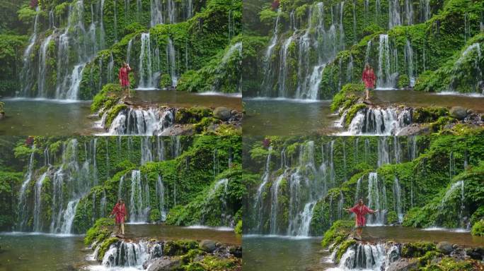 一名女子站在巴厘岛清新的瀑布旁