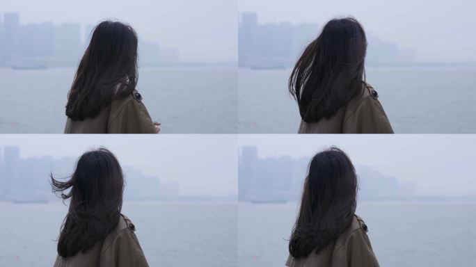 女人站在城市江边望向远处背影