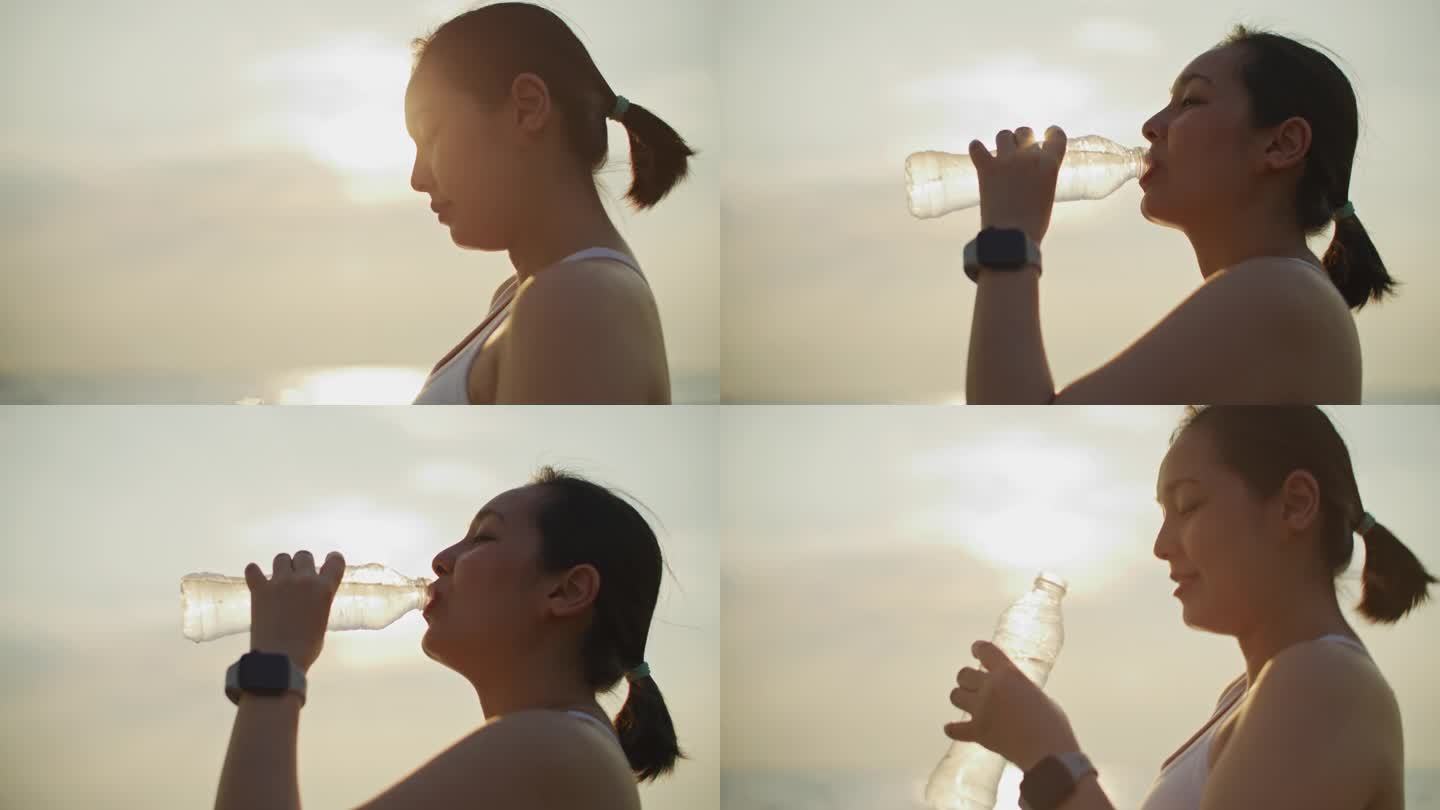 高强度运动后，年轻女子正在用冷水补水