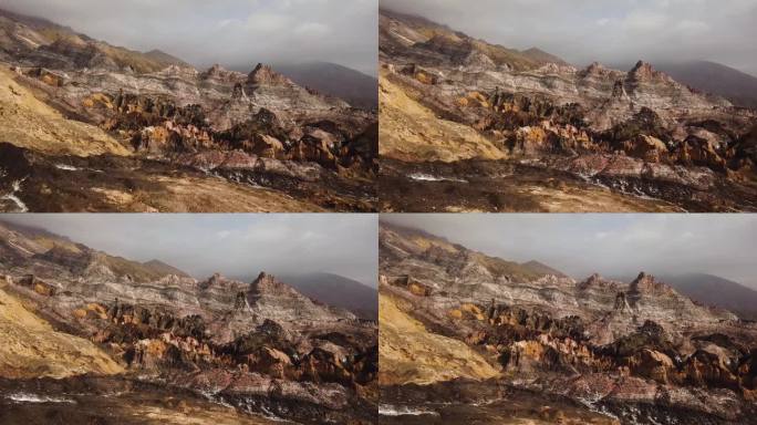 奇妙的盐山彩色岩石地质自然景观军事视图彩虹山令人惊叹的全景灰金色无人机拍摄在中东伊朗高原雾云在徒步旅