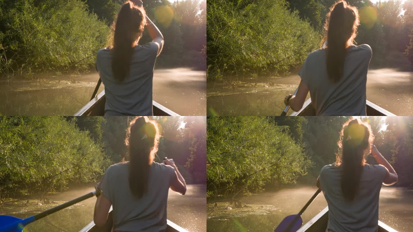 年轻的女旅行者在独木舟上欣赏日落时的自然美景
