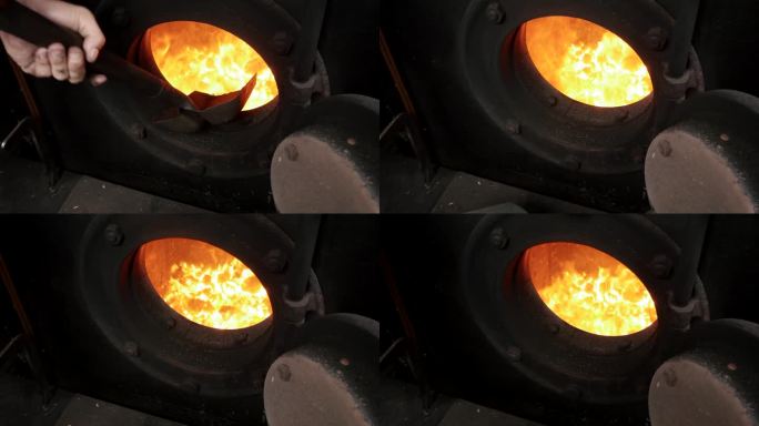 一名男子正在开动蒸汽机锅炉，将木炭装入烤箱