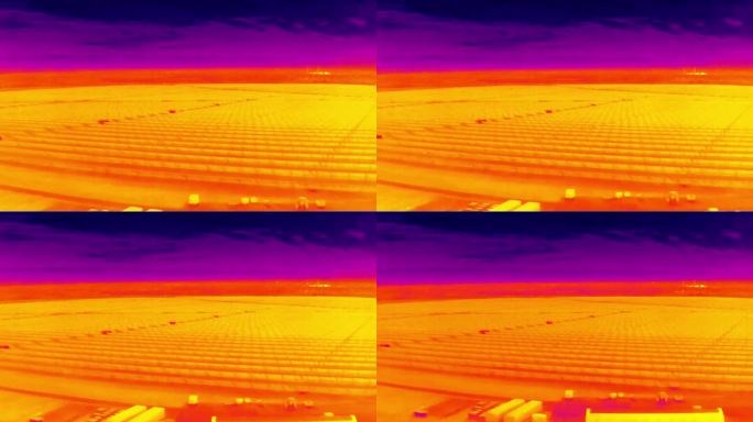 大型光伏农场太阳能发电厂的航空红外热视图，紫色和黄色色调