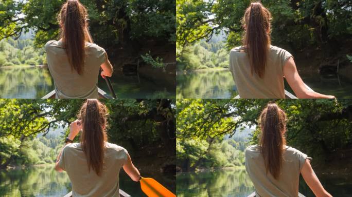 夏天，女子在平静的河流上划独木舟