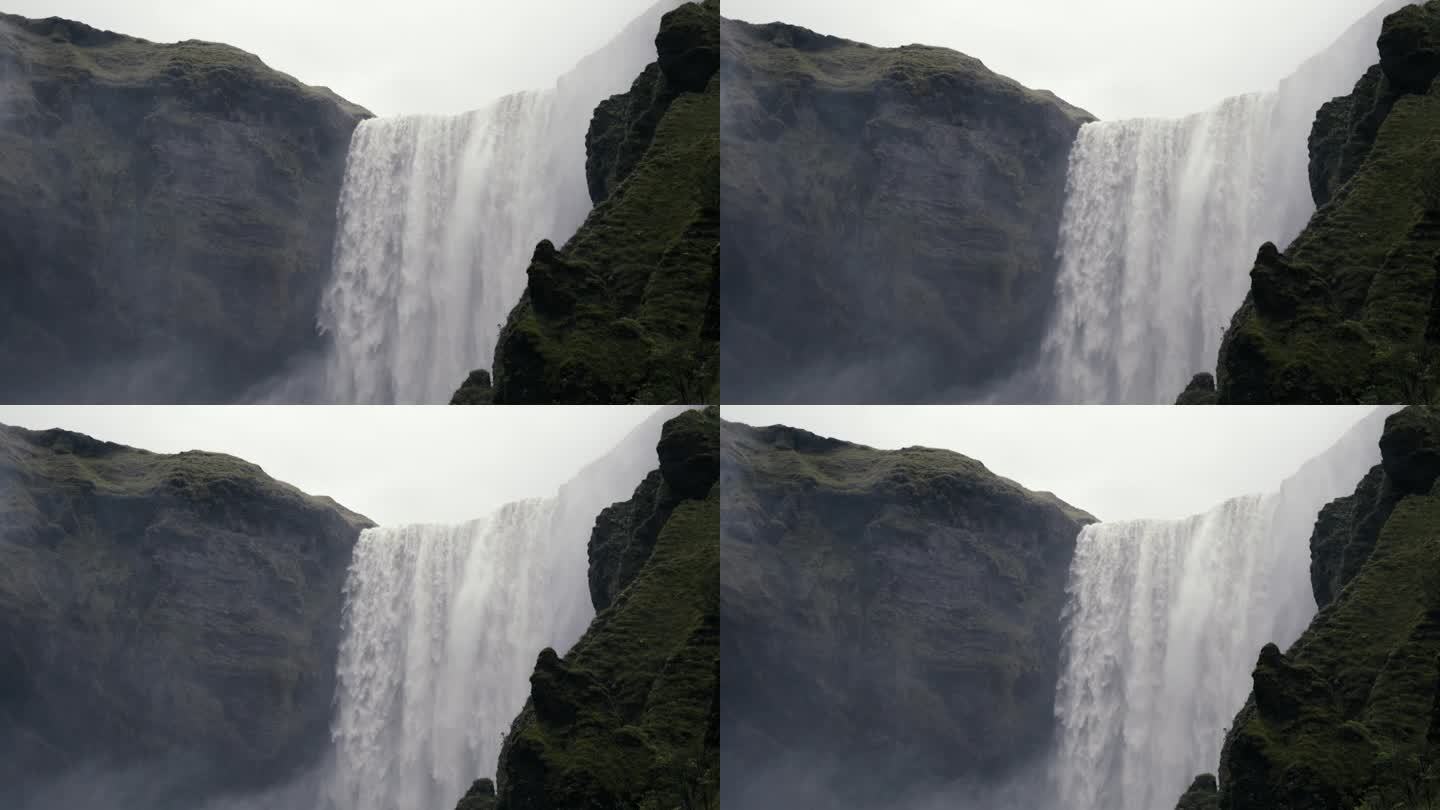大瀑布的广角镜头，水从末日悬崖上倾泻而下。用辉煌的慢动作拍摄。Skogafoss冰岛。