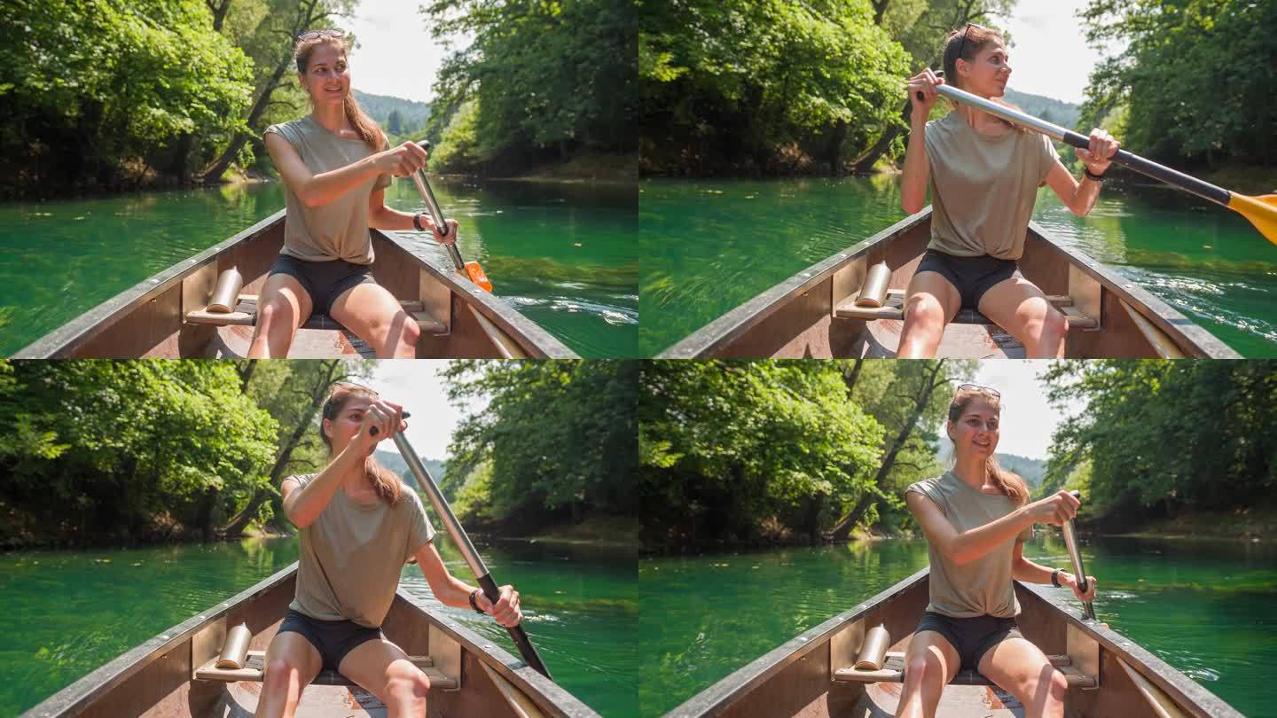 夏天，年轻的女旅行者在独木舟上欣赏风景优美的大自然