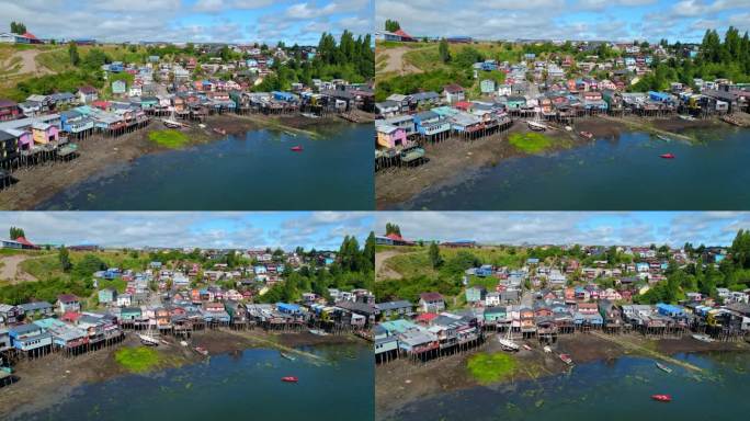 空中无人机高脚楼彩色村庄在岛海chilo<e:1>智利巴塔哥尼亚旅游目的地建立拍摄，绿色的小岛山丘与