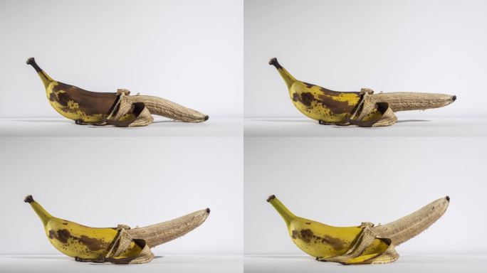 香蕉活过来了，在白色的背景下升起。男性权力概念。两周的时间间隔