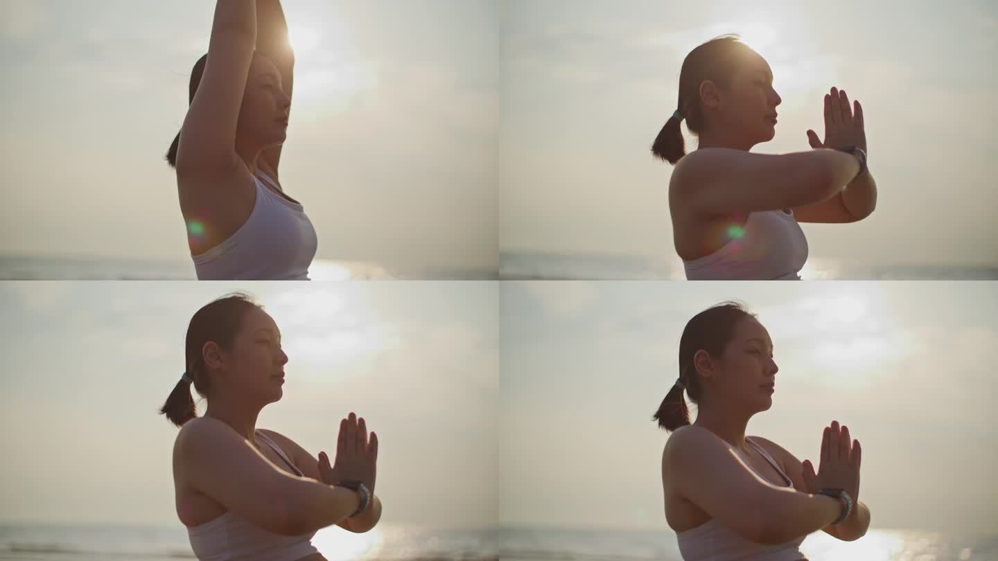 年轻的孕妇在海滩上练习瑜伽