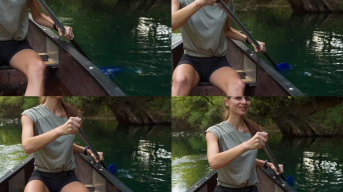 一个女人在独木舟上探索一条美丽的河流