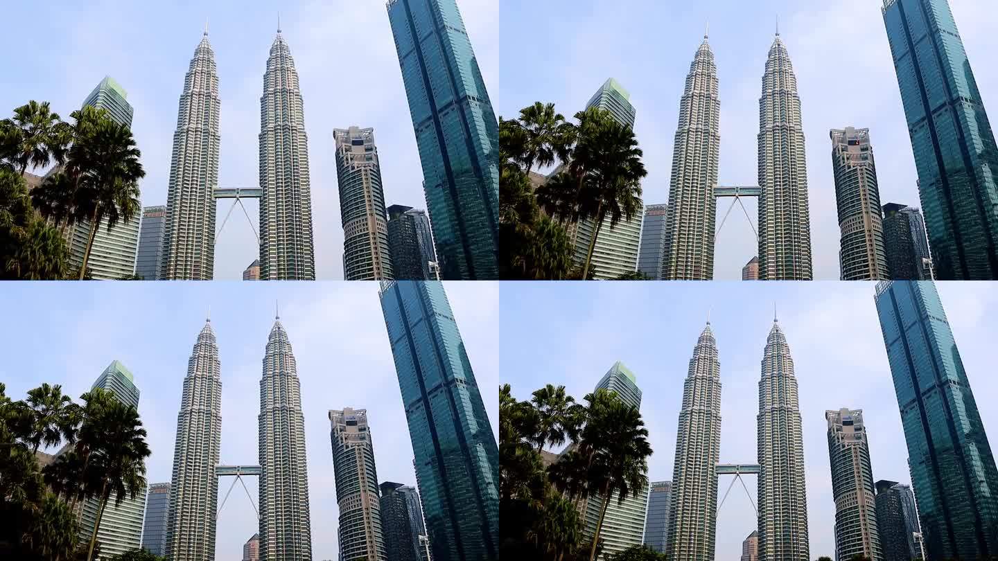 马来西亚吉隆坡的一个重要标志，双子塔的时间流逝，建筑周围的美丽景观在早上。
