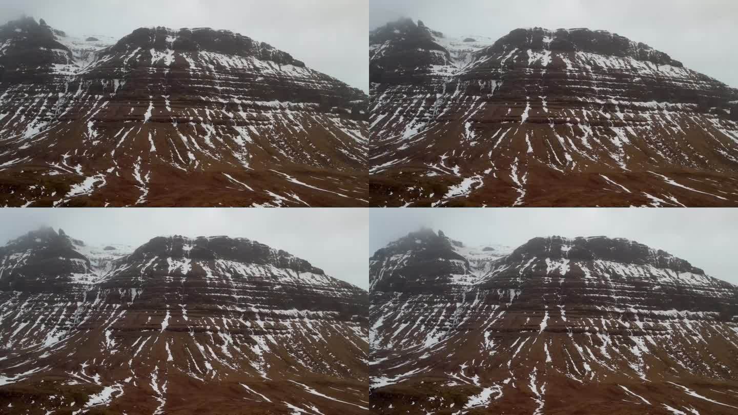 来自4K无人机的高质量镜头，展示了在恶劣天气条件下冰岛山顶的空中，电影和独特视角。