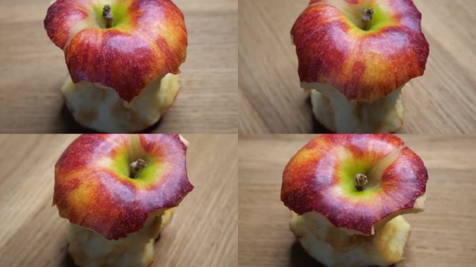一个大苹果的残根。吃了一半的红苹果特写。一个苹果的核心是春晚的品种，轮换。宏观的视频。
