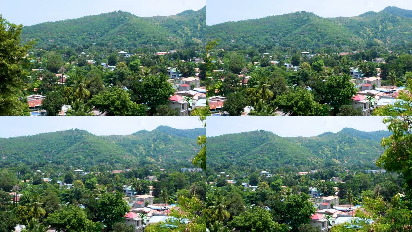 位于东南亚东帝汶首都帝力的当地社区住宅坐落在绿树和山丘之间，风景优美
