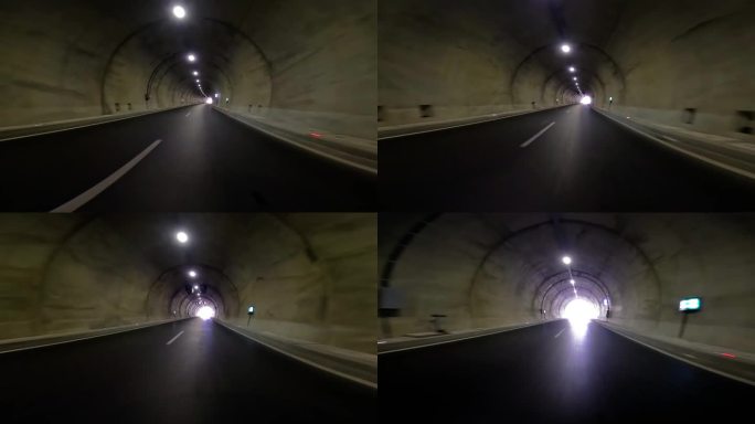 汽车驶出隧道，公路上一片漆黑。从汽车镜头显示隧道出口，强调汽车，隧道过渡。捕捉汽车，隧道出口进入高速