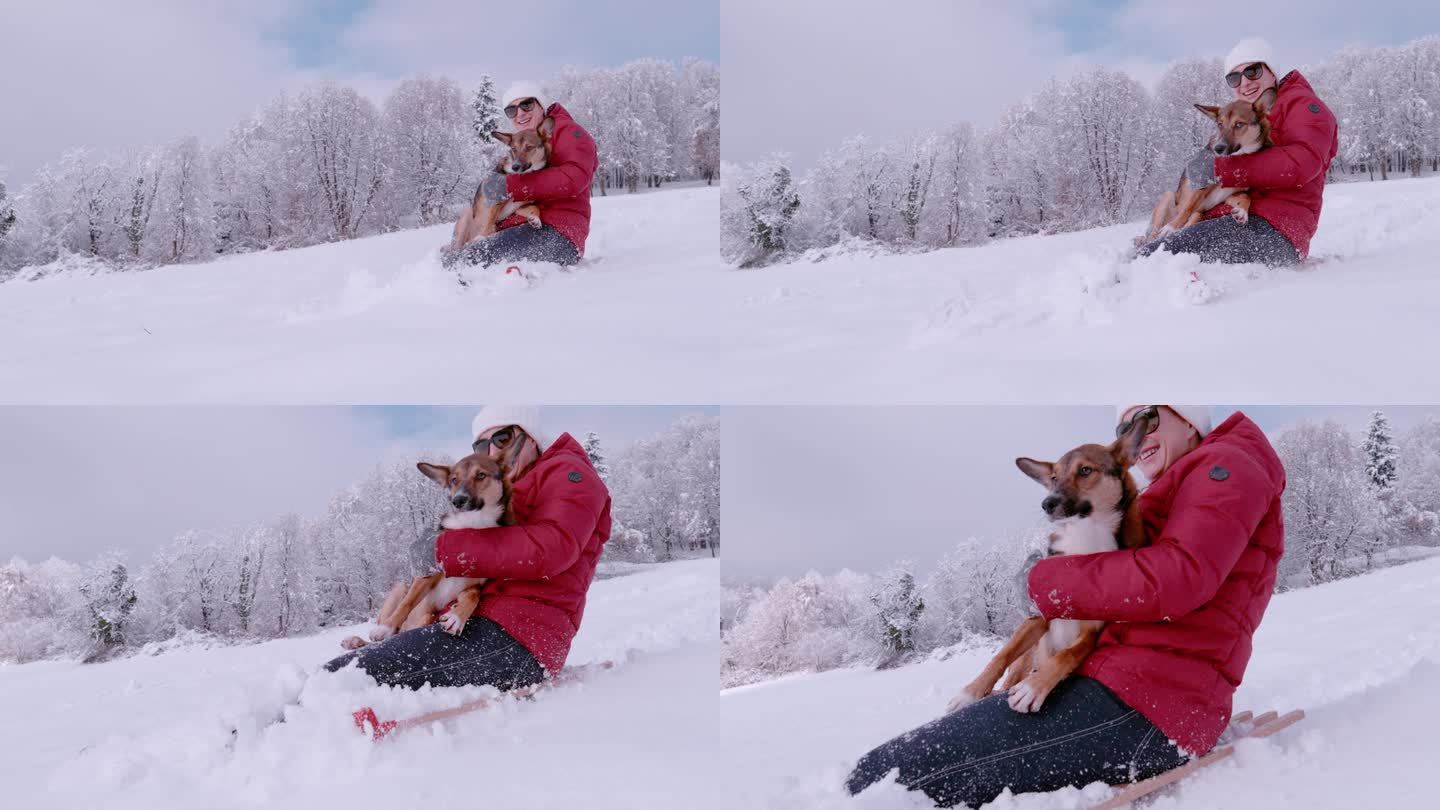 一位微笑的女士抱着她可爱的狗狗在新下雪的雪地上滑雪