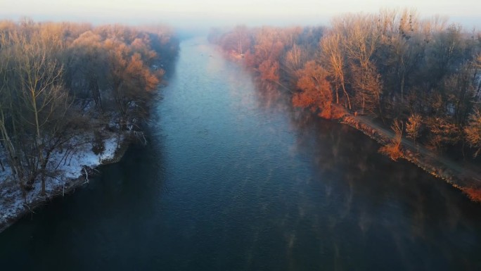 风景秀丽的穆尔河在树林中的冬季森林景观笼罩着雾在黎明