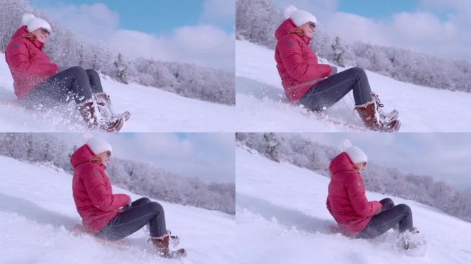 慢镜头:在一个阳光明媚的日子里，年轻的女士在刚下完雪的雪橇上大笑