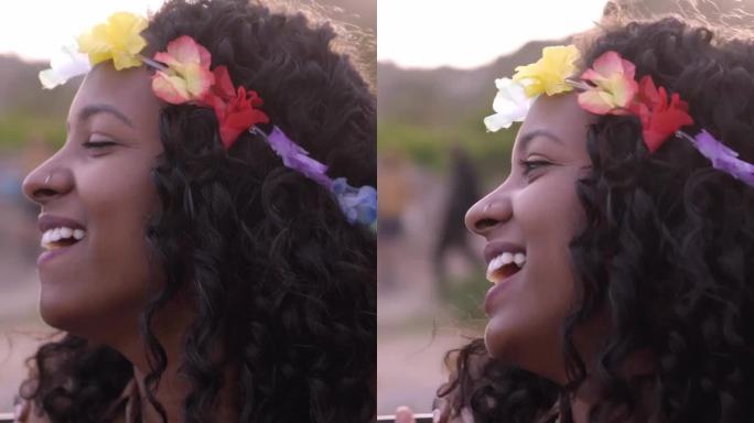 一群朋友在海滩聚会上玩得很开心，非裔美国妇女在户外唱歌。