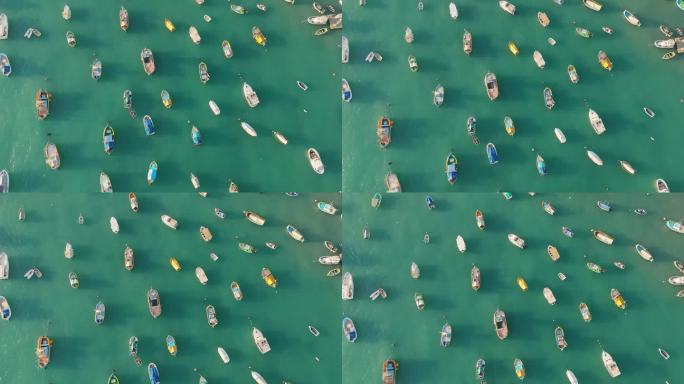 从空中俯瞰停泊在海湾的渔船。马尔他马萨斯洛克港有许多小型私人渔船