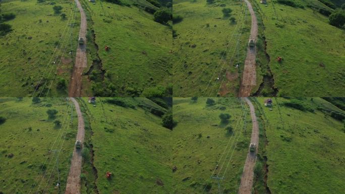 鸟瞰图，一辆4x4越野车在红色的越野赛道上穿过绿色的热带稀树草原