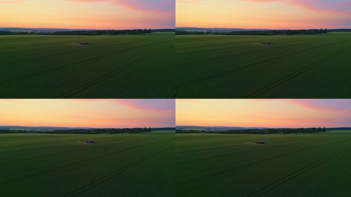 无人机空中交响乐:黄昏时，拖拉机在农业进步的挂毯上喷洒绿色的田野
