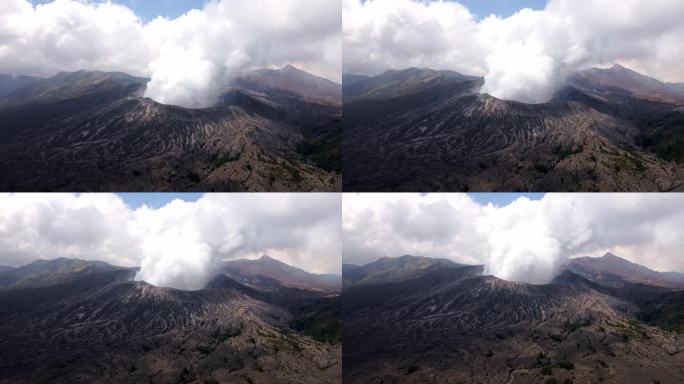 4k空中无人机拍摄的火山喷发危险而令人颤抖的时刻，厚厚的云层笼罩着活火山布罗莫山的火山口