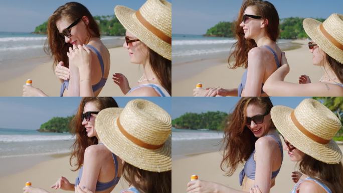 一名女子在沙滩上给自己的手涂防水防晒霜。快乐的女孩们在海边涂上防水防晒霜。使用防晒系数进行日光浴的女