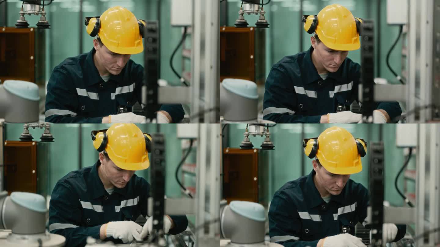 未来制造业:熟练的工业工程师操作机械臂的控制面板-提高工厂效率。