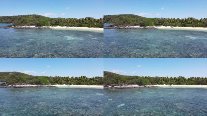 4K无人机拍摄的热带岛屿海滨、涨潮时的棕榈树和珊瑚礁。德拉瓦卡，亚泽，斐济