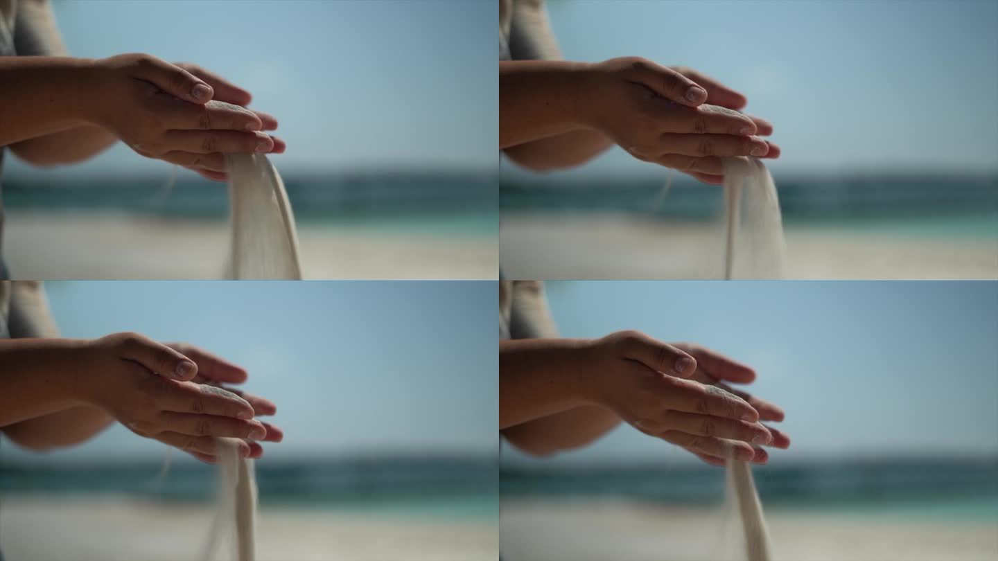海边沙滩上的沙子从手上倒出来的慢动作视频