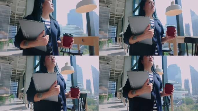 亚洲休闲女性拿着笔记本电脑和咖啡走进咖啡馆远程工作