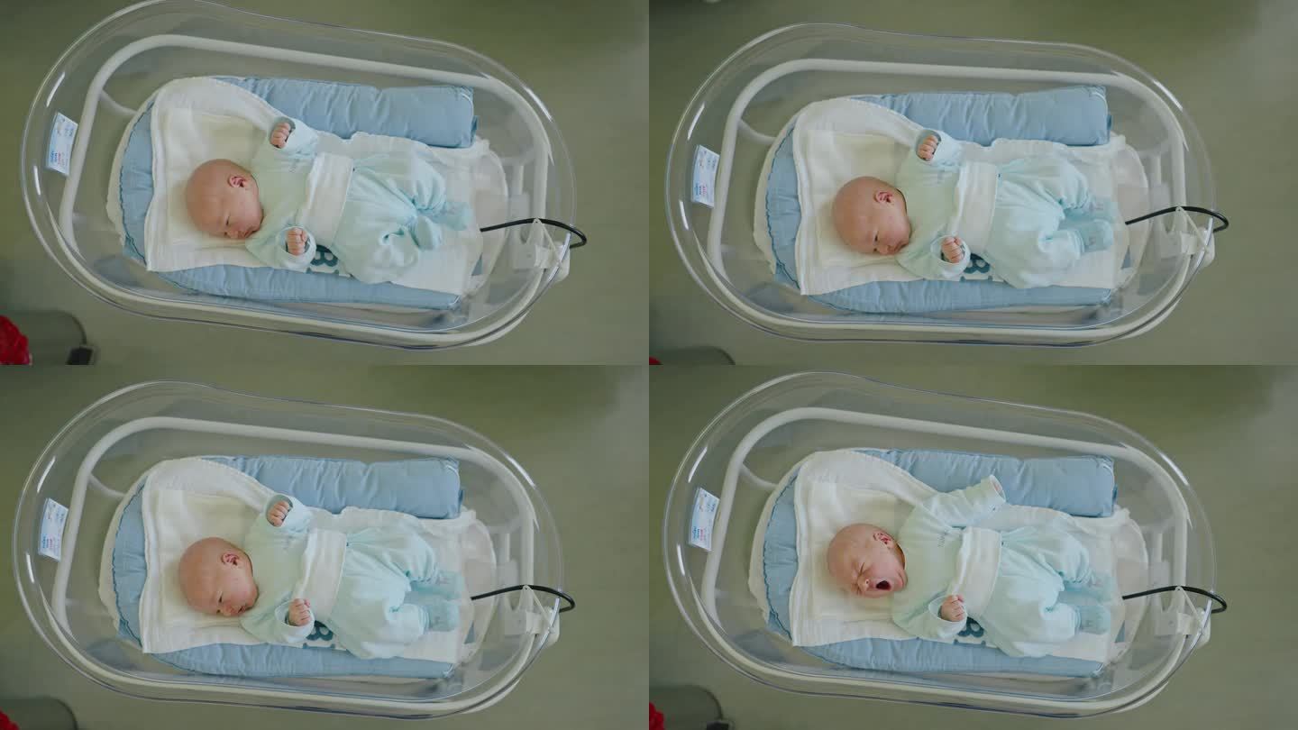 小哈欠:刚出生的男婴在产科病房的婴儿床里找到了安宁