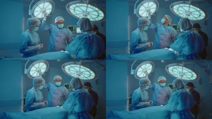 一位外科医生正在修理一个大灯，并调整它，以便他的手术有完美的照明，护士们站在他周围。拍摄于ARRI