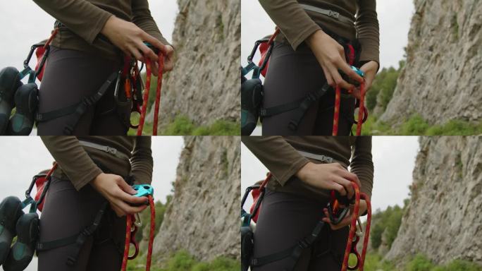 女登山者将绳子系在锁扣上
