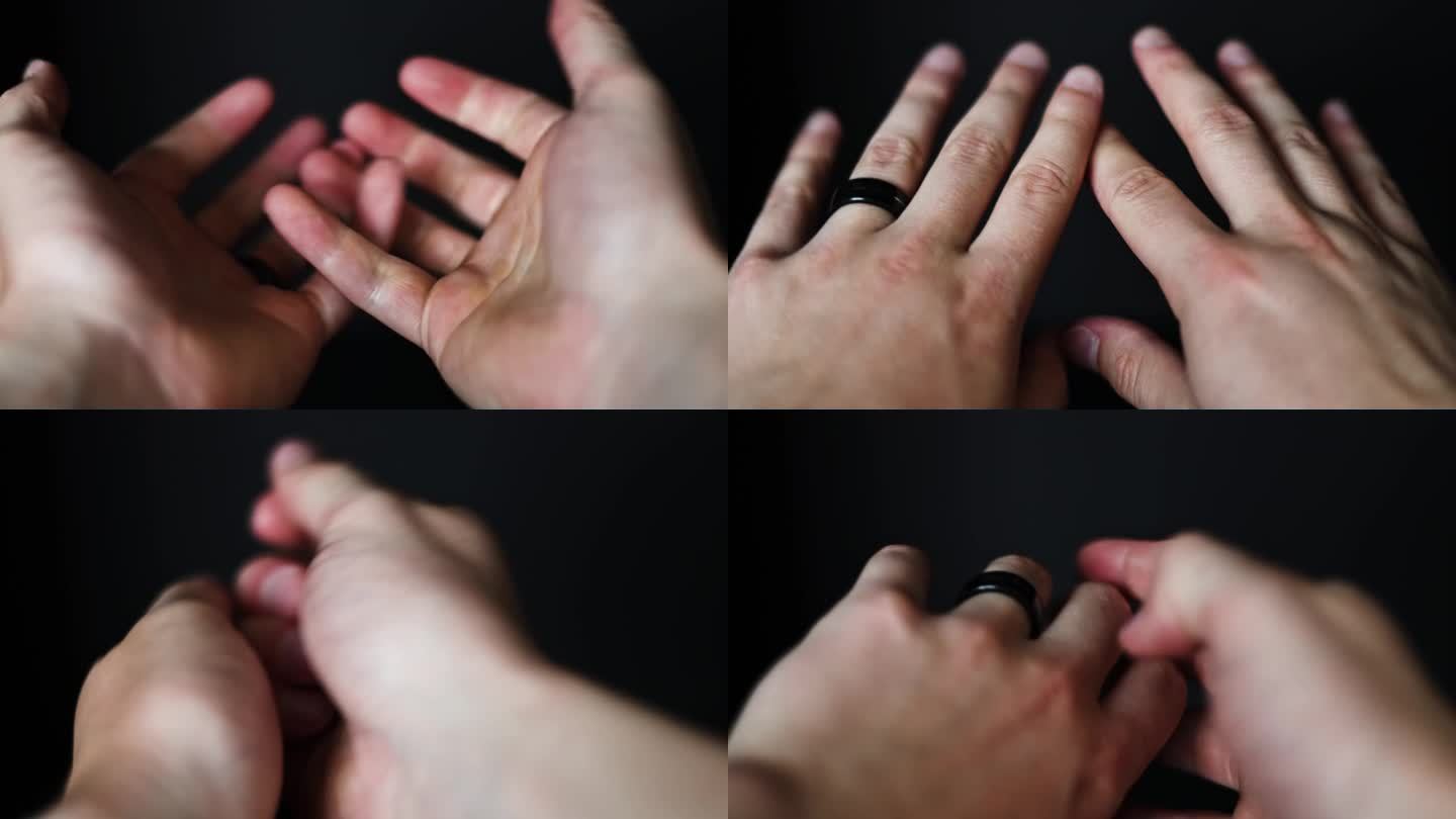 白种人的手戴着黑色背景的黑色结婚戒指