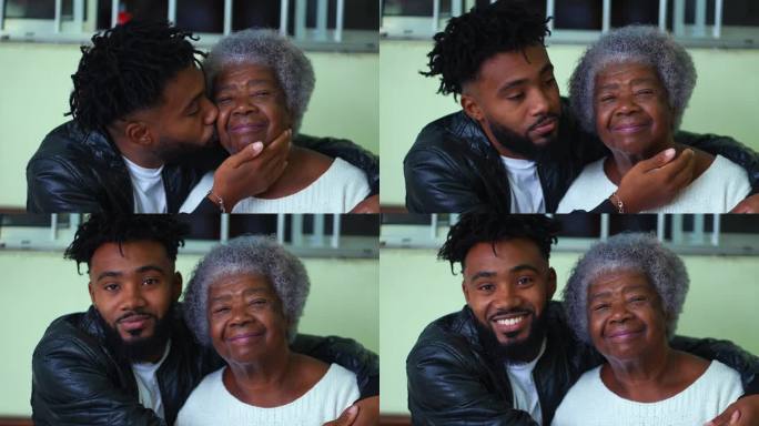 20多岁的年轻非裔美国孙子亲吻年迈的祖母的脸颊，深情地拥抱着家中的长辈，温柔的代际纽带