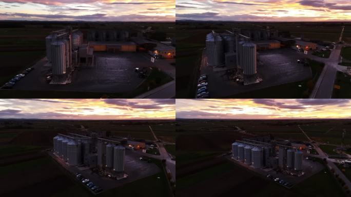 黄昏时分，无人机在农村农场的停车场拍摄筒仓