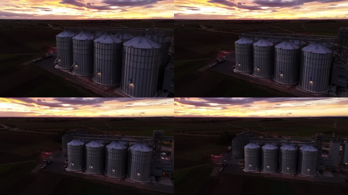 缩小黄昏时无人机在农场拍摄的筒仓