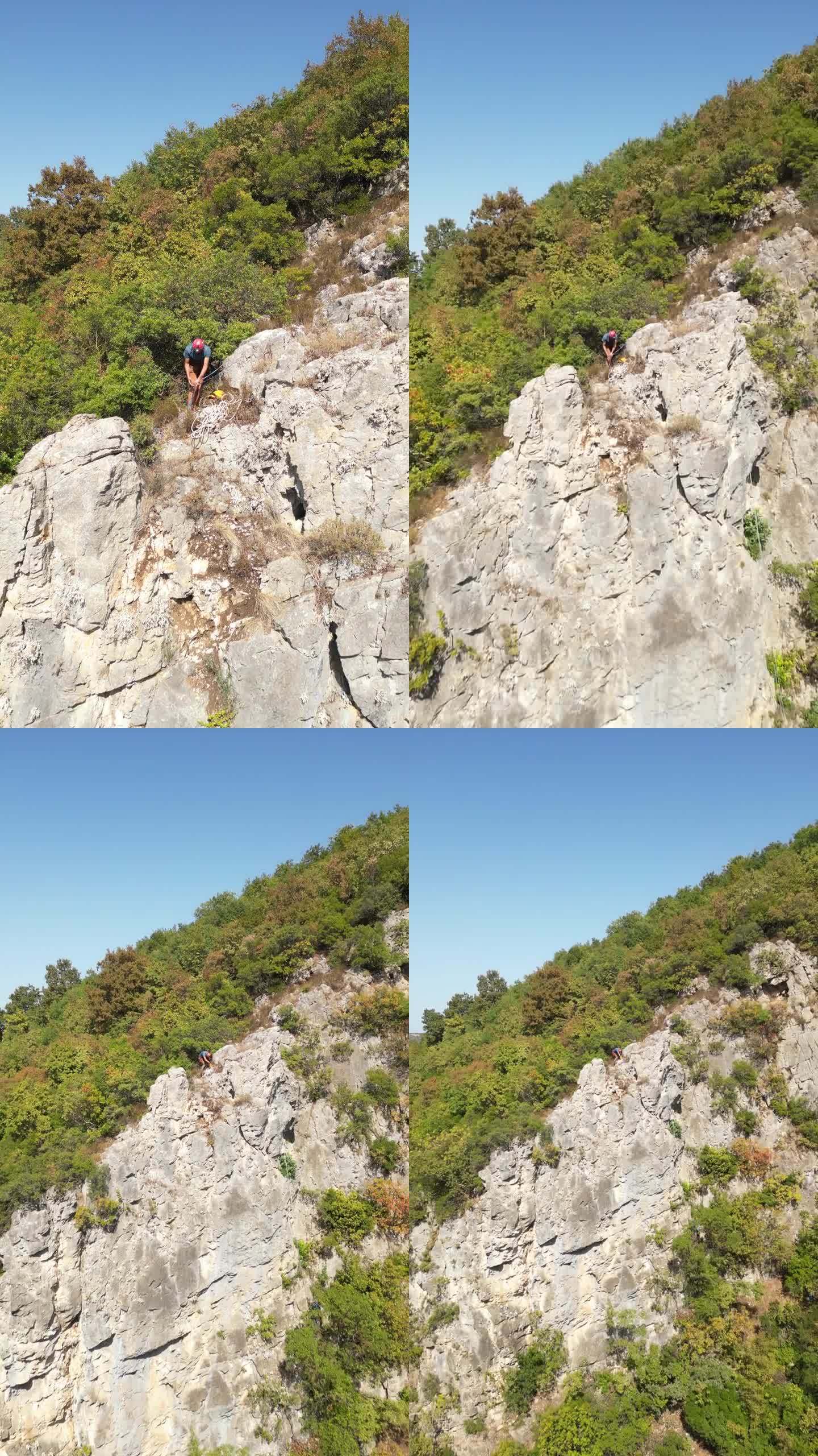 戴着红色安全帽的攀登者在岩石顶部准备攀爬绳，准备下山。