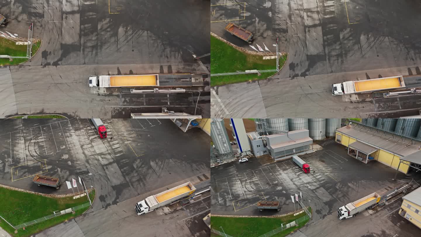 无人机拍摄到满载谷物的拖车从筒仓驶出