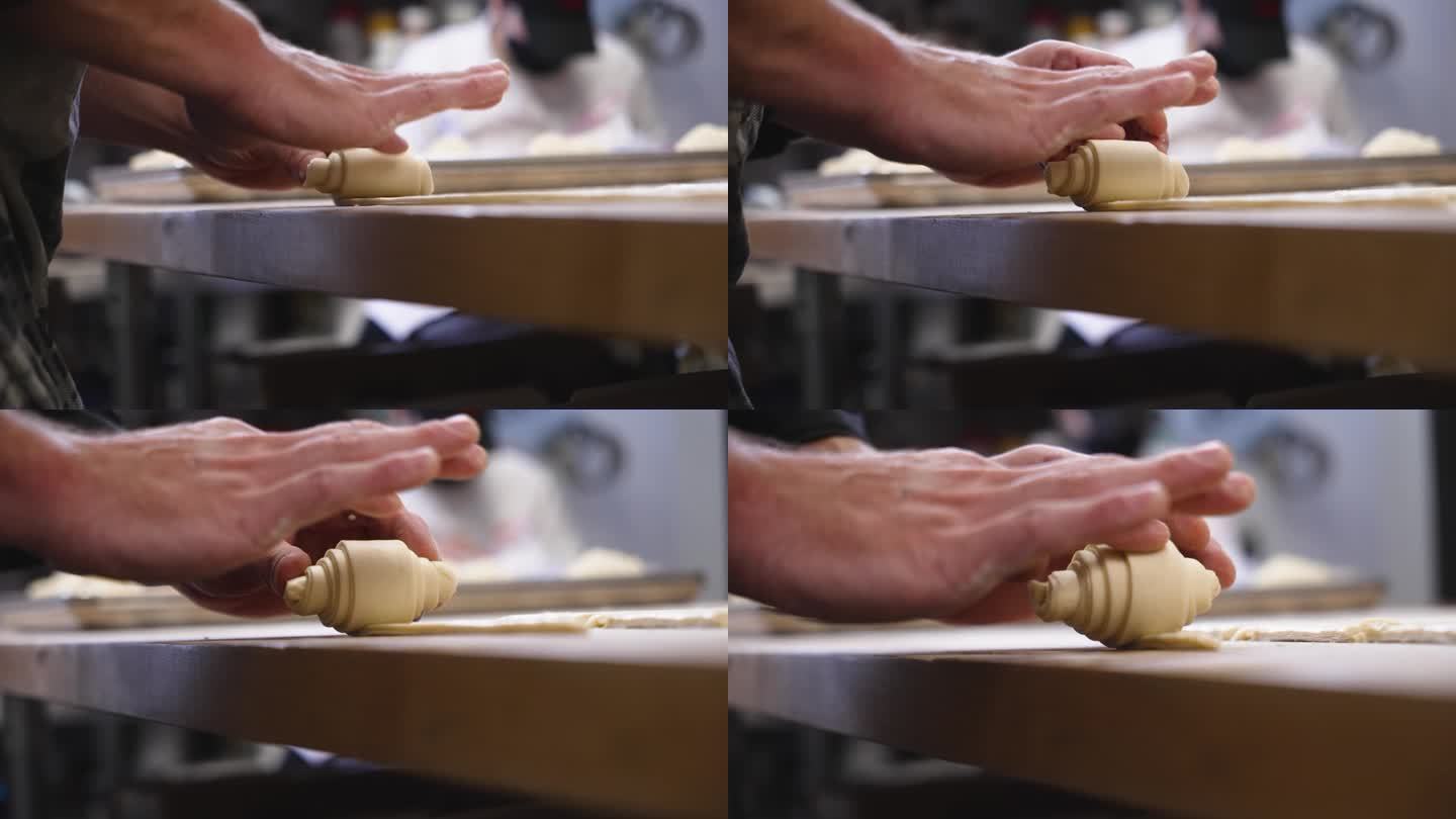 糕点师用食指在柜台上精致地卷黄油牛角面包面团，慢镜头近4K