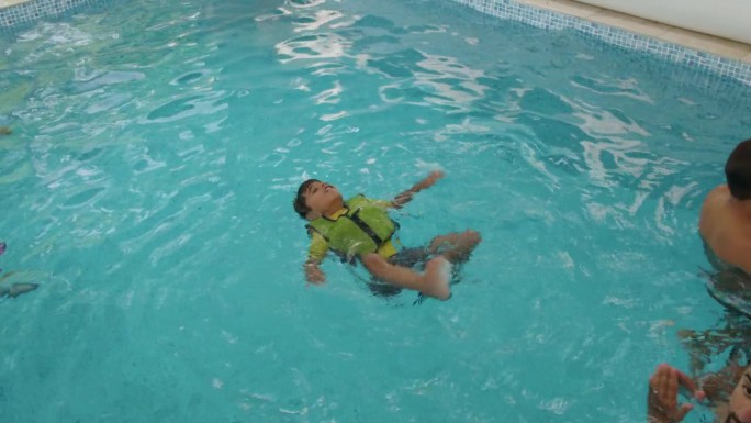 父亲看着儿子游泳亲情时刻水上运动陪伴成长