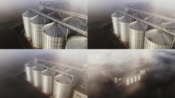 时间扭曲效果/速度斜坡无人机在农场的乡村筒仓上拍摄空灵的雾